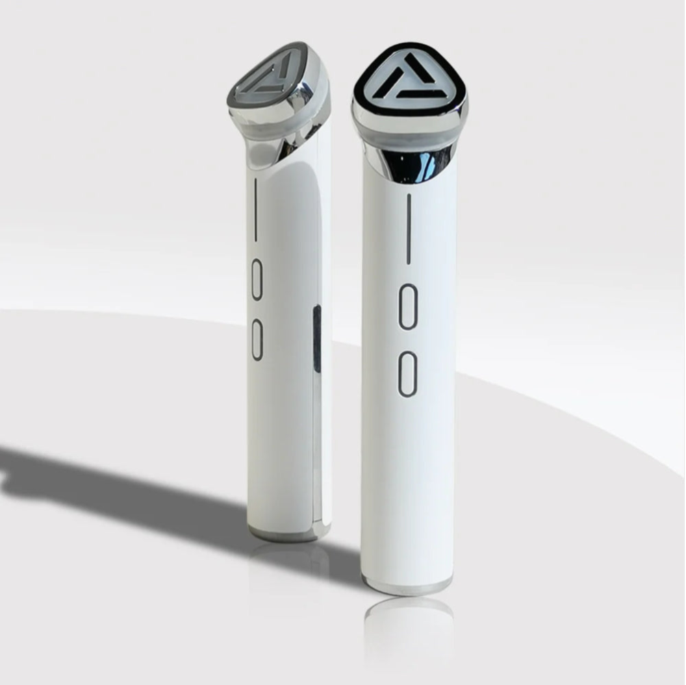 Two sleek electronic devices, identical in shape and color, representing the 3-in-1 Lumipore Rejuvenator RF beauty tool.